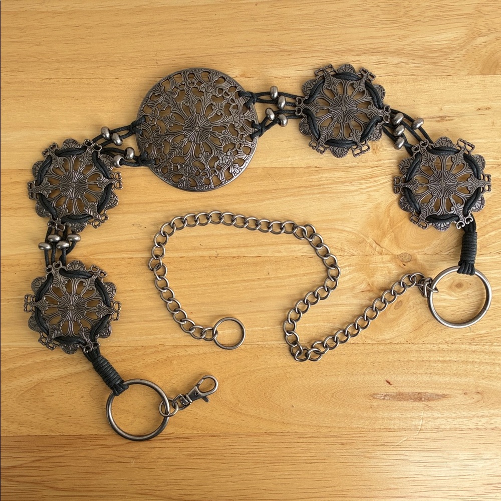 Metal and black cord medallion belt. 46 inches.